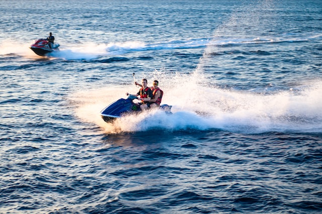 a group of tourists riding on a jet skiis