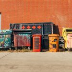 five coloured dumpsters