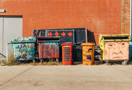 five coloured dumpsters