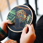 person doing embroidery