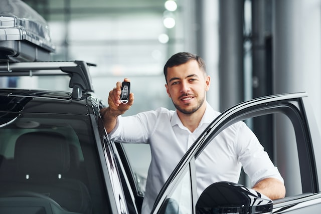 person holding keys from a car