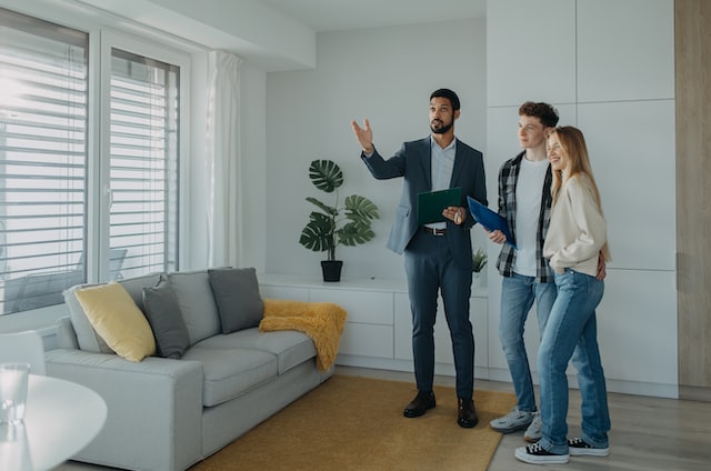 person showing the apartments to wife and husband