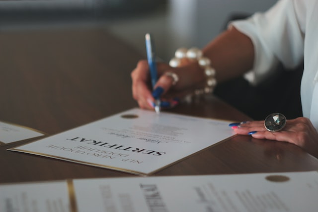 person writing on a certificate